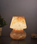 Glass Mushroom LED Bedside Lamp For Bedroom And Living Room on nightstand with warm glow, hand-blown orange glass mood lamp