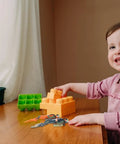 Set Of 2 Cool Realistic Scuba Diver Figures For Your Fish Tank next to building blocks, on a table with a smiling child.