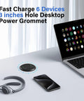Slick Flush Mount Desk Power Hub With Two AC Outlets And Four Quick Charge Ports Including Dual PD 20W Type C Plugs on desk next to a laptop and headset.