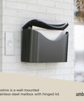 Postino Wall Mount Mailbox in brushed stainless steel with hinged lid, weatherproof and envelope-inspired design on brick wall