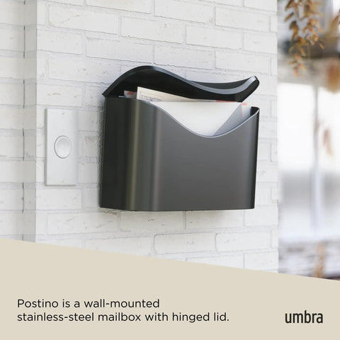 Postino Wall Mount Mailbox in brushed stainless steel with hinged lid, weatherproof and envelope-inspired design on brick wall