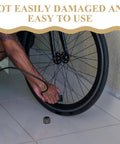 Person inflating bike tire with Rugged Aluminum Thru Axle Nut M15x1.5mm For Mountain Bikes And Electric Bikes Easy Install Durable Hub Nut nearby