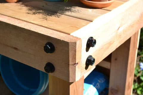 Corner view of wooden outdoor structure with 10 Pcs Aluminum Hex Cap Nuts And 10 Hex Cap Nut Plugs One And One Half Inch Decorative Covers