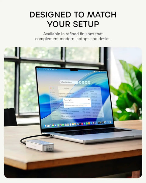 Rad Speed 80Gbps NVMe SSD Enclosure With Direct Hook Up USB4 V2 Connector and Active Cooling beside a laptop during file transfer.