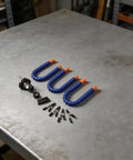Components of Three Arm Soldering Helping Hands Station With Adjustable Clips laid out on a workbench.
