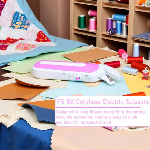 No Sweat Cordless Electric Scissors That Slays Through Heavy Fabric And Leather With Ergonomic Handle And Safety Guard For Reliable Sewing And Workshop Upgrades Now on a cutting table with fabric scraps.