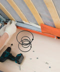 Heavy Duty Six Inch Sofa Spring Repair Kit installation process with black steel coil springs and a drill for couch restoration.