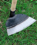 Heavy Duty Garden Hoe Tool with solid manganese steel blade on grass for weeding, soil loosening, and planting in backyard and farm