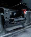 Slick Under Seat Fire Extinguisher Bracket For Ineos Grenadier Truck With One Hand Quick Release Aluminum Mount Kit and Heavy Duty Secure Ratchet Straps close-up view of mounting plate and red release knob.