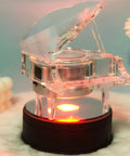 Fieifi Motorized Rotating Led Light Display Base For Crystals And Glass Art showing a crystal piano figurine on a black round LED base.
