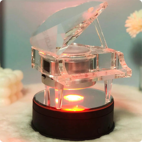 Fieifi Motorized Rotating Led Light Display Base For Crystals And Glass Art showing a crystal piano figurine on a black round LED base.