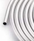 Close-up of a coiled Three Eighths Inch Aluminum Fuel Hard Line Coil Ten Foot Roll For Your Ride High Performance Car Fuel System 0.035 Inch Wall 3003 Aluminum Lightweight Corrosion Resistant Tubing.