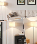 Black floor lamp with white fabric shade, 60in tall, foot pedal switch; bulb not included, shown in living room collage.