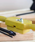 Plastic Dowel Thread Tap Kit For Woodworking Three Quarters Inch Dowel Jig Set With Tap Die in yellow on wood surface
