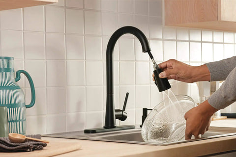 Precept Pull-Down Kitchen Faucet, 1.5 GPM, Matte Black Finish in use, showing Powerinse 3-Function Sprayer for extra cleaning