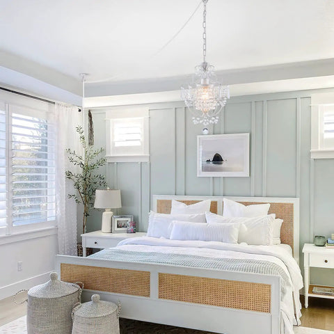 Plug In Mini Crystal Chandelier hanging in a stylish bedroom with modern decor and large windows behind the bed.