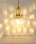 JAZAVA 10-Inch Brushed Gold Pendant Light, Modern Farmhouse Hanging Fixture with Ribbed Glass Shade illuminated.