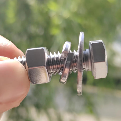 Side close-up of stainless steel 3/8-16x1-1/4 hex head bolt with nuts and flat and lock washers