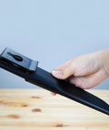 Hand holding black sheath for Outdoorsman Lite 6 Inch Fixed Blade Knife With 4116 Stainless Steel Textured Kraton Handle.