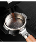 Dope Titanium Espresso Distributor And Ground Leveling Tool For Even Coffee Bed Prep In 58.5mm Portafilter Baskets with coffee grounds being dispensed.