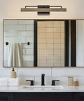 Modern Farmhouse Integrated LED Vanity Light Bar, 24W 3000K Warm White Glow, 25-Inch Hand-Painted Wood Grain Metal Linear Sconce With Smoked Birch And Black Finish over a bathroom mirror.
