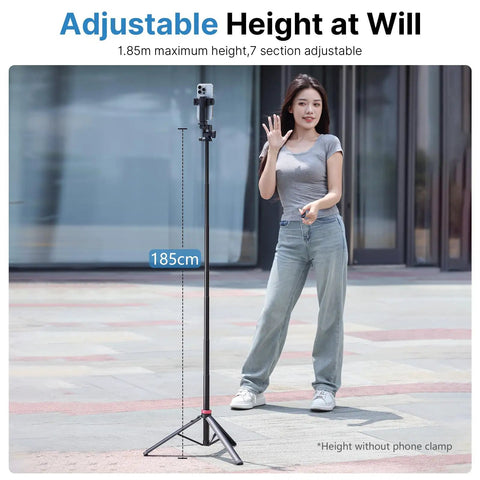 Woman standing next to Extendable Phone Tripod With 2 In 1 Phone Clip And 360 Degree Ball Head Aluminum Selfie Stick Stand Reaches Up To 82 Inches