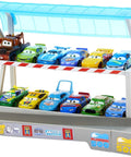 Toy cars lined up on the Ultimate Florida Speedway Track Set with Lightning McQueen Car and Motorized Booster, 5 feet long.