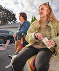 Woman holding Classic Easy Fill Wide Mouth 8 Oz Hip Flask With Leakproof Hinge Cap; tailgating scene with cars in background