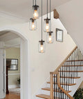 5 Light Mason Jar Chandelier Pendant For Kitchen Island And Dining Room, hanging in a rustic staircase with bronze canopy