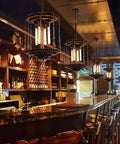 Bar interior with pendant lights using Dimmable T10 LED Filament Tubular Bulbs 4000K Daylight White, clear glass cover, Edison style.