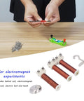 Classroom Magnetic Field Experiment Kit With Helical Coil And Electric Bell, hands testing copper coil components on table