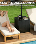 Outdoor Umbrella Side Table With Hole 2 In 1 Square Patio Table For Poolside And Deck Includes 15.9 Gallon Fillable Base Fits Up To 1.5 Inch Pole Matte Black Space Saving Durable And Easy To Set Up near lounge chairs by a pool.