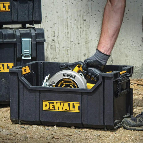 Heavy Duty Tool Organizer Bag For Tough System Stacks With Large Open Interior For Bulk Storage Holds Spray Cans Cables And Tools Durable Polypropylene Tote With Side Carry Handle And Stacking Latch For Easy Transport. Man placing tool inside the tote.