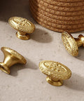 Antique Brass Cabinet Knobs 4 Pack Copper Oval Handles on a surface, showcasing a vintage design for kitchen and bathroom cabinets.