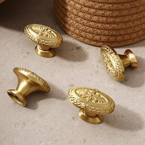 Antique Brass Cabinet Knobs 4 Pack Copper Oval Handles on a surface, showcasing a vintage design for kitchen and bathroom cabinets.