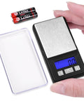 Ultra Mini Pocket Scale 1000G Capacity With 0.1G Increments and clear LCD display, shown with tray and batteries, ideal for portable use