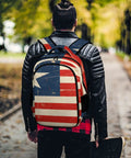 Antique Distressed Star Stripe Flag Printed Unisex Backpack worn by person in park, showcasing durability and style.