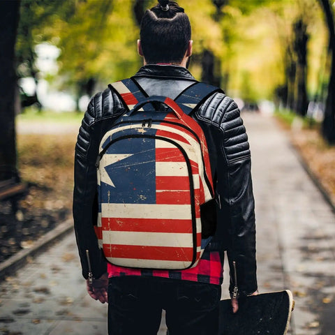 Antique Distressed Star Stripe Flag Printed Unisex Backpack worn by person in park, showcasing durability and style.