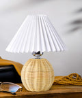 Korean Pleated DIY Ceramic Table Lamp With Rattan Accent In White For Living Room Decor on wooden surface, glasses beside