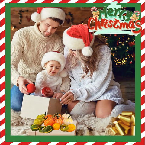 Family in Santa hats sitting by a Christmas tree, opening a gift box, with colorful gourds and festive decorations around them.