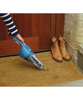 Person using Cordless Handheld Vacuum For Home And Car Cleaning, Lightweight Grab-And-Go Dustbuster on doormat
