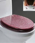 Sick Pink Glitter Toilet Seat With Super Slick Soft Close Lid And No Drama Quick Release Hardware For Easy Bathroom Scrubbing, mounted on a toilet.