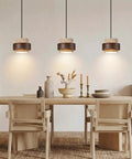 Axamate Wabi Sabi Pendant Light Natural Stone Chandeliers Dia 8" illuminating a rustic dining table with natural decor.