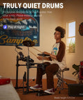 Person playing DED-80 Electronic Drum Set With 4 Quiet Mesh Pads in a cozy room, showcasing headphones and solid drum throne.