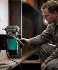 User adjusting the Game Changing Magnetic Drill Press With 1450W Copper Motor, featuring smooth RPM settings for metal fabrication.