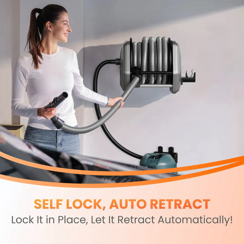 Woman using a wall-mounted retractable vacuum hose reel with 30ft hose extension, 1-1/4 inch, for 32mm wet dry vacuums in garage