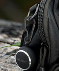 Black Titanium Carabiner Keychain With Quick Release Clip And Bottle Opener Small 2 Inch Key Clip attached to a black bag