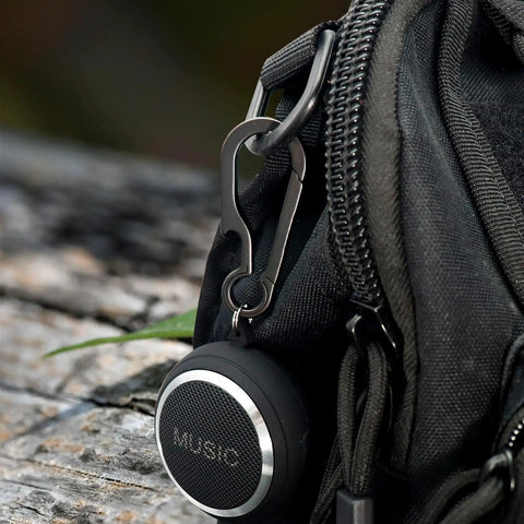 Black Titanium Carabiner Keychain With Quick Release Clip And Bottle Opener Small 2 Inch Key Clip attached to a black bag