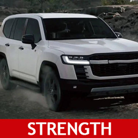 White SUV driving on a rocky terrain showcasing strength.