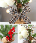Close-up of Three Piece Tabletop Christmas Tree Set with red berries, pinecones, nuts, and bows, ready to display on a cozy desk or fireplace